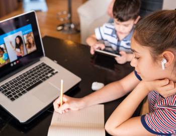 students learning from home on laptop