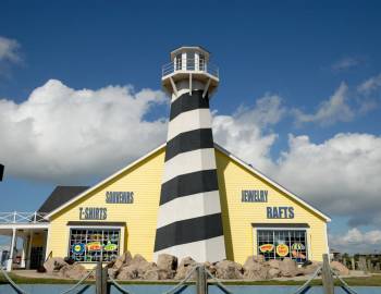 One of the top Port Aransas gift shops can be seen, shopfront shaped like a lighthouse.